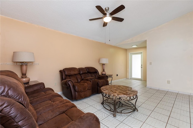 living room with vaulted ceiling, ceiling fan, light tile patterned flooring, and baseboards