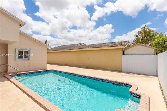 view of swimming pool with a patio, a fenced in pool, and fence