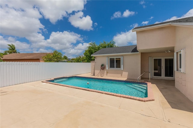 view of swimming pool featuring a patio area, a fenced in pool, french doors, and fence