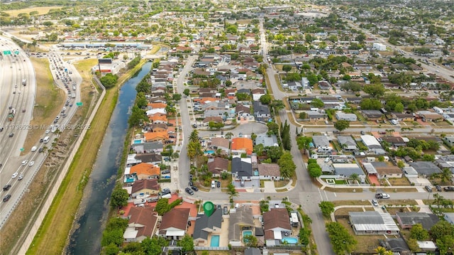 drone / aerial view with a water view and a residential view