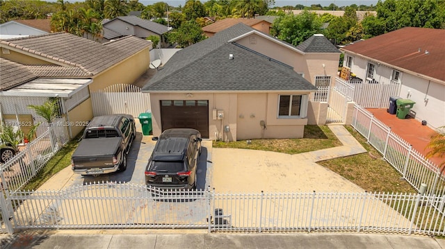view of front facade featuring driveway, a garage, stucco siding, roof with shingles, and a gate