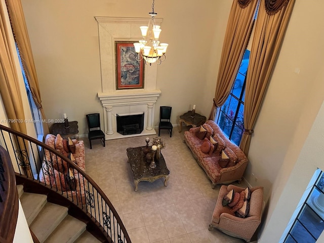 living room with baseboards, stairs, tile patterned floors, and a chandelier
