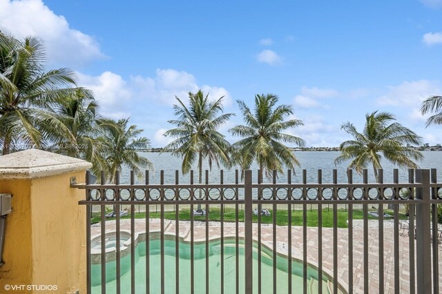 19058 SW 17th Ct, Miramar, FL 33029 - gate with a water view, a pool with connected hot tub, and fence