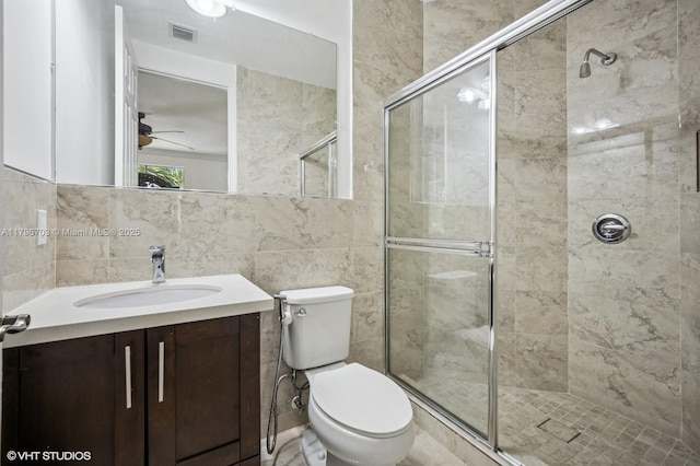 19058 SW 17th Ct, Miramar, FL 33029 - bathroom featuring a stall shower, ceiling fan, toilet, vanity, and tile walls