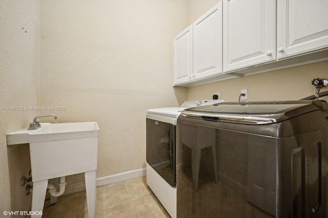 19058 SW 17th Ct, Miramar, FL 33029 - washroom featuring separate washer and dryer, cabinet space, baseboards, and light tile patterned floors