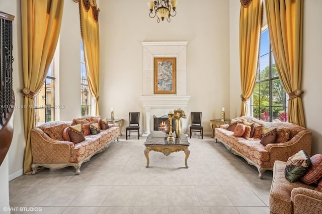 19058 SW 17th Ct, Miramar, FL 33029 - living area featuring tile patterned floors, a lit fireplace, and a chandelier