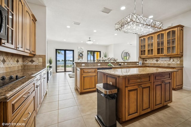 19058 SW 17th Ct, Miramar, FL 33029 - kitchen with brown cabinetry, a peninsula, tasteful backsplash, and recessed lighting