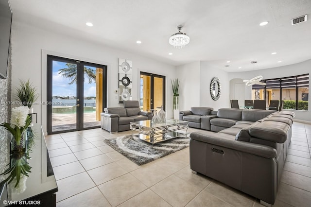 19058 SW 17th Ct, Miramar, FL 33029 - living area with french doors, a chandelier, light tile patterned flooring, recessed lighting, and arched walkways