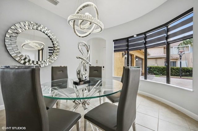 19058 SW 17th Ct, Miramar, FL 33029 - tiled dining area with baseboards, a chandelier, and arched walkways