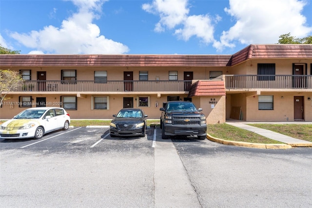 view of building exterior with uncovered parking