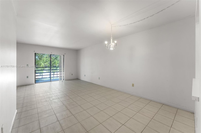empty room featuring an inviting chandelier and light tile patterned flooring