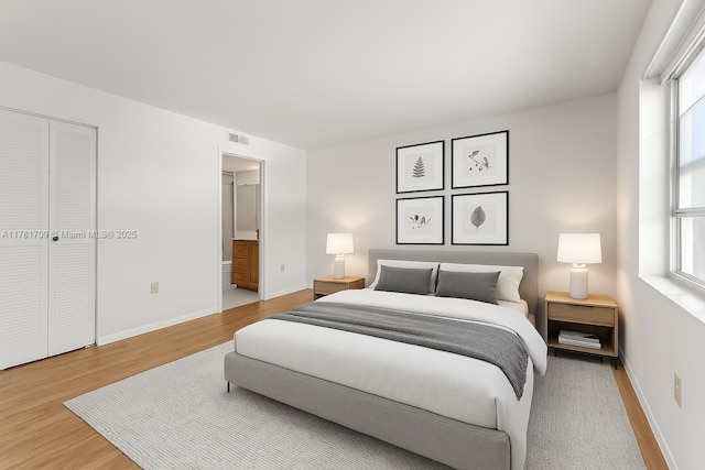 14859 SW 104th St Unit 8-203, Miami, FL 33196 - bedroom featuring wood finished floors, multiple windows, connected bathroom, and a closet