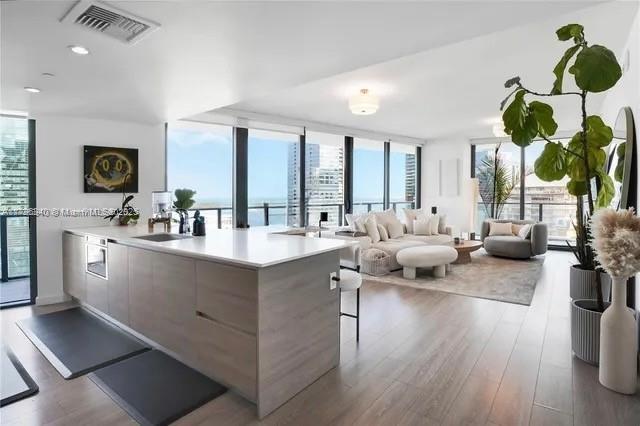 1300 S Miami Ave Unit 3405, Miami, FL 33130 - kitchen featuring floor to ceiling windows, visible vents, modern cabinets, and dark wood-type flooring