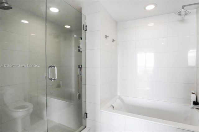full bathroom featuring a relaxing tiled tub, a stall shower, and recessed lighting