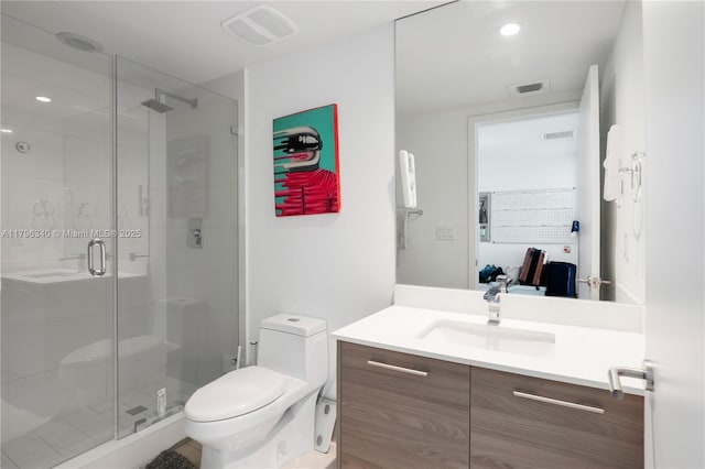 full bath featuring a shower stall, visible vents, toilet, and vanity