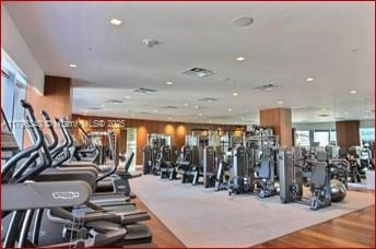 exercise room featuring recessed lighting and wood finished floors