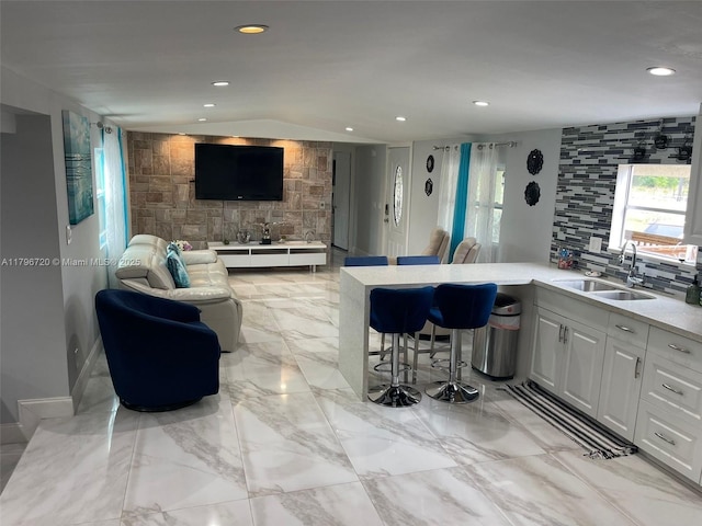 493 Camino Real Blvd, Clewiston, FL 33440 - kitchen featuring open floor plan, recessed lighting, a sink, and a kitchen bar