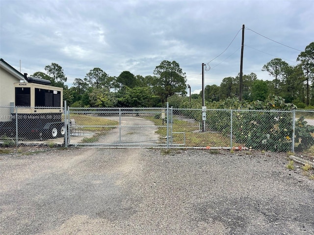 493 Camino Real Blvd, Clewiston, FL 33440 - view of road with a gate, a gated entry, and driveway