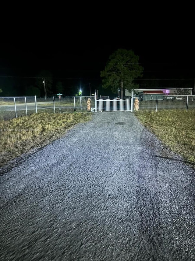 493 Camino Real Blvd, Clewiston, FL 33440 - exterior space with a gated entry and gravel driveway