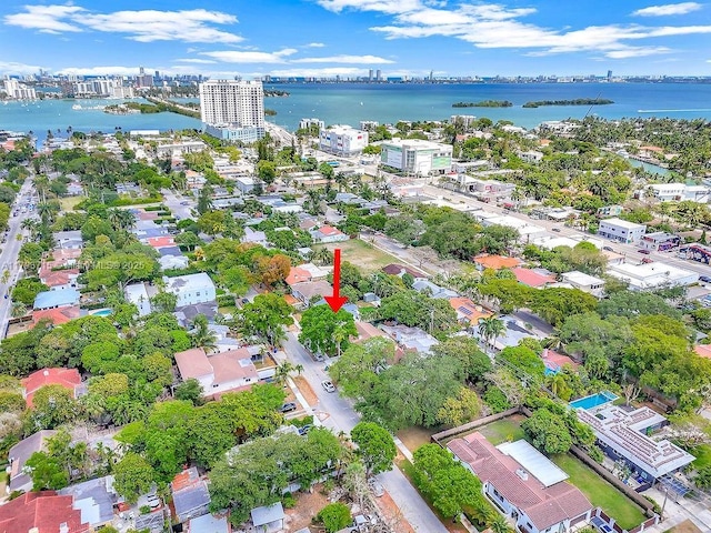 birds eye view of property with a water view and a city view
