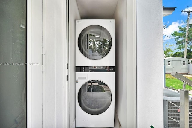 laundry area featuring stacked washing maching and dryer and laundry area