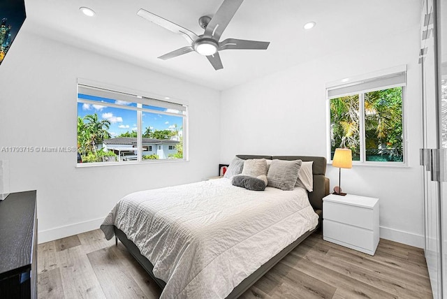 bedroom featuring recessed lighting, baseboards, and multiple windows