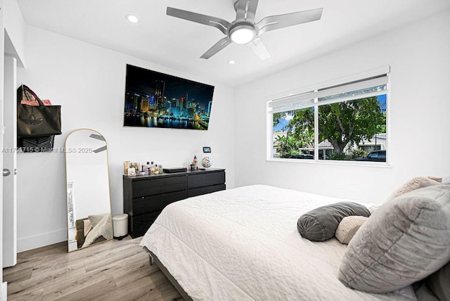 bedroom with a ceiling fan, baseboards, recessed lighting, and wood finished floors