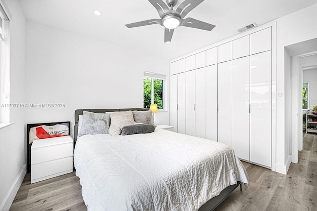 bedroom with light wood-type flooring, visible vents, baseboards, and recessed lighting