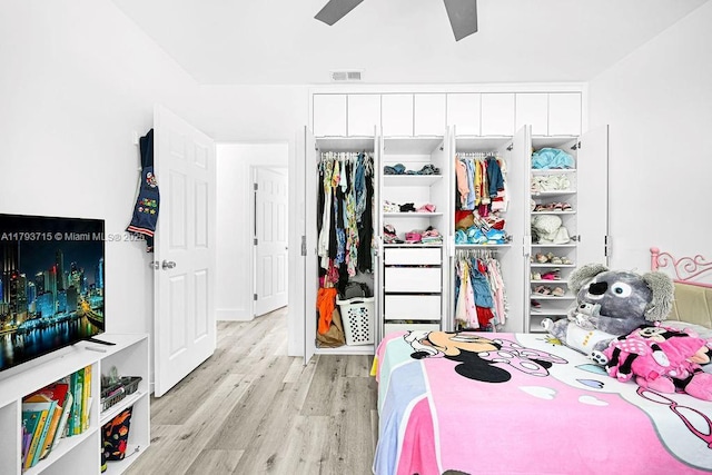 bedroom featuring ceiling fan, light wood-style flooring, a closet, and visible vents