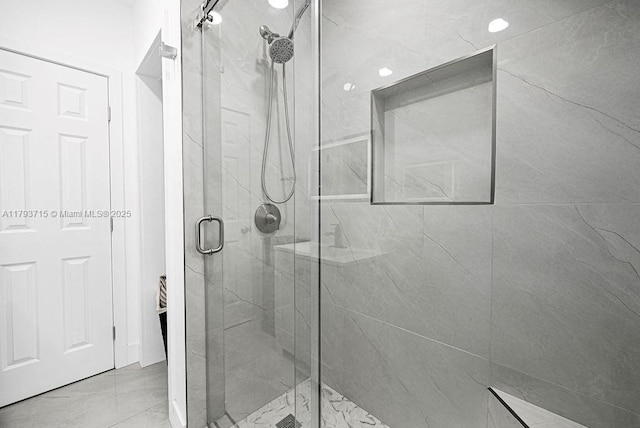 full bathroom featuring a marble finish shower