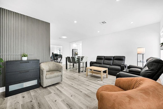 living area featuring recessed lighting, visible vents, and light wood-type flooring