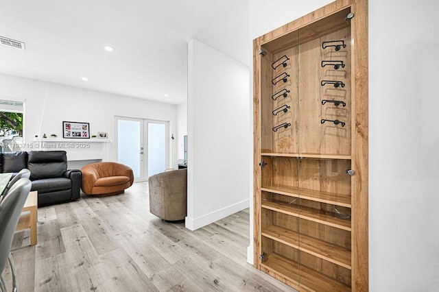 interior space with french doors, recessed lighting, baseboards, visible vents, and light wood-style floors