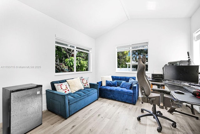 home office featuring lofted ceiling and wood finished floors