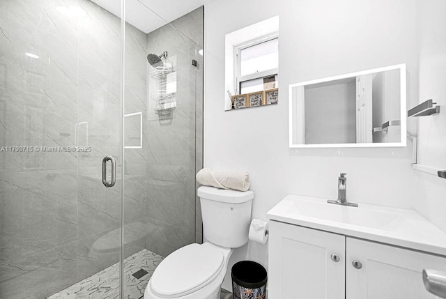 full bath featuring vanity, toilet, and a shower stall