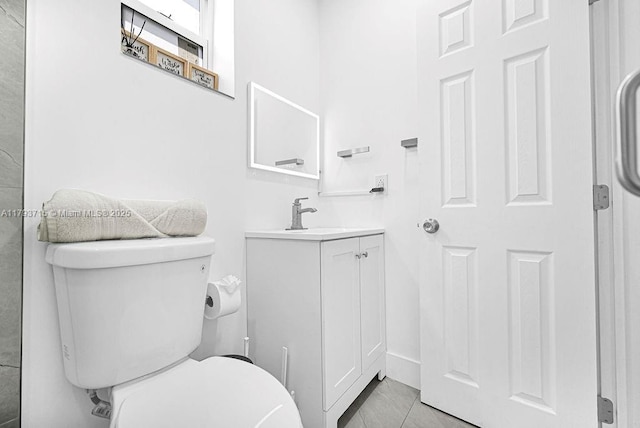 bathroom with tile patterned floors, toilet, and vanity