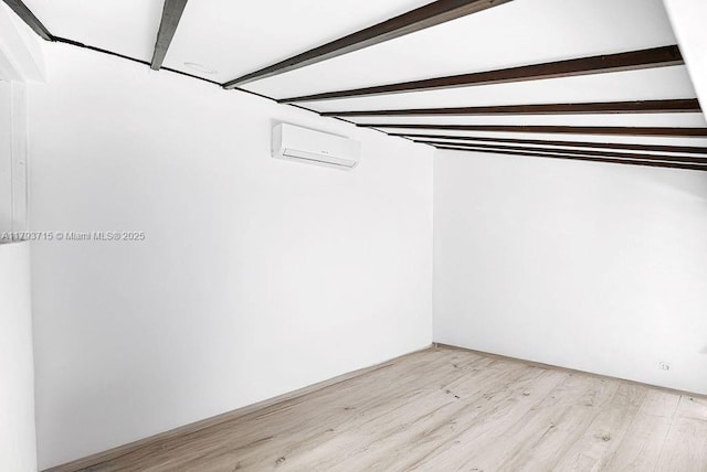 walk in closet with light wood-type flooring and a wall unit AC