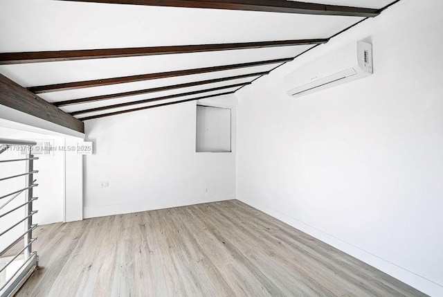 below grade area with a wall mounted air conditioner and wood finished floors