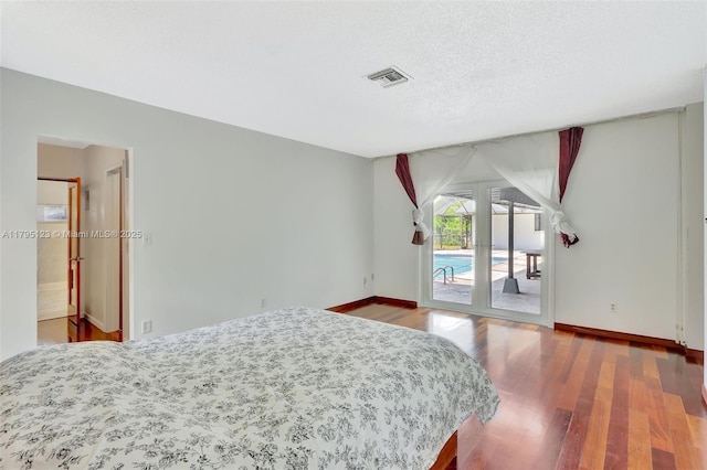 7600 SW 124th St, Pinecrest, FL 33156 - bedroom with access to exterior, wood finished floors, and a textured ceiling