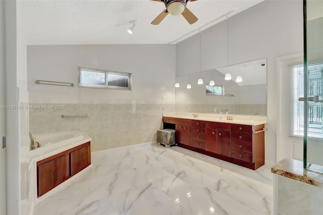 7600 SW 124th St, Pinecrest, FL 33156 - full bath with tile walls, double vanity, a bath, ceiling fan, and marble look tile flooring
