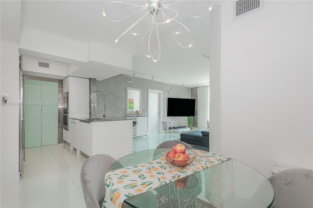 dining area featuring a chandelier, light tile patterned floors, and visible vents