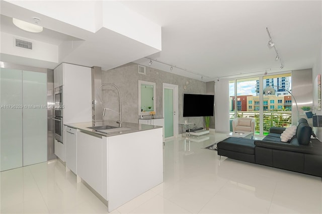 kitchen with white cabinetry, visible vents, and track lighting