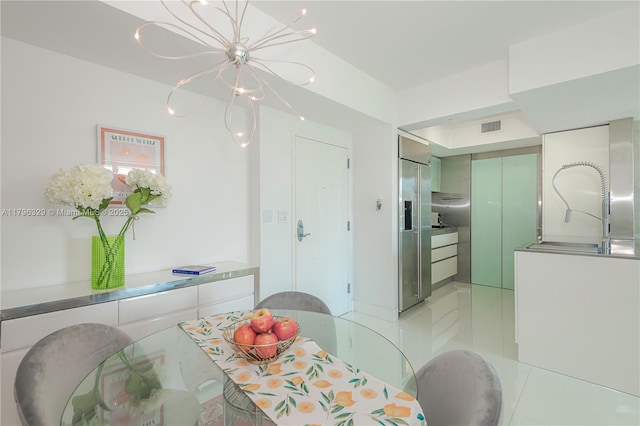 dining area featuring an inviting chandelier, light tile patterned flooring, and visible vents