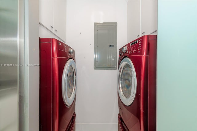 laundry room featuring electric panel, cabinet space, and washing machine and clothes dryer