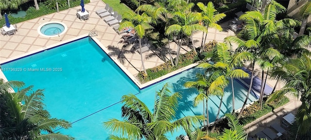 community pool featuring a patio area and a community hot tub