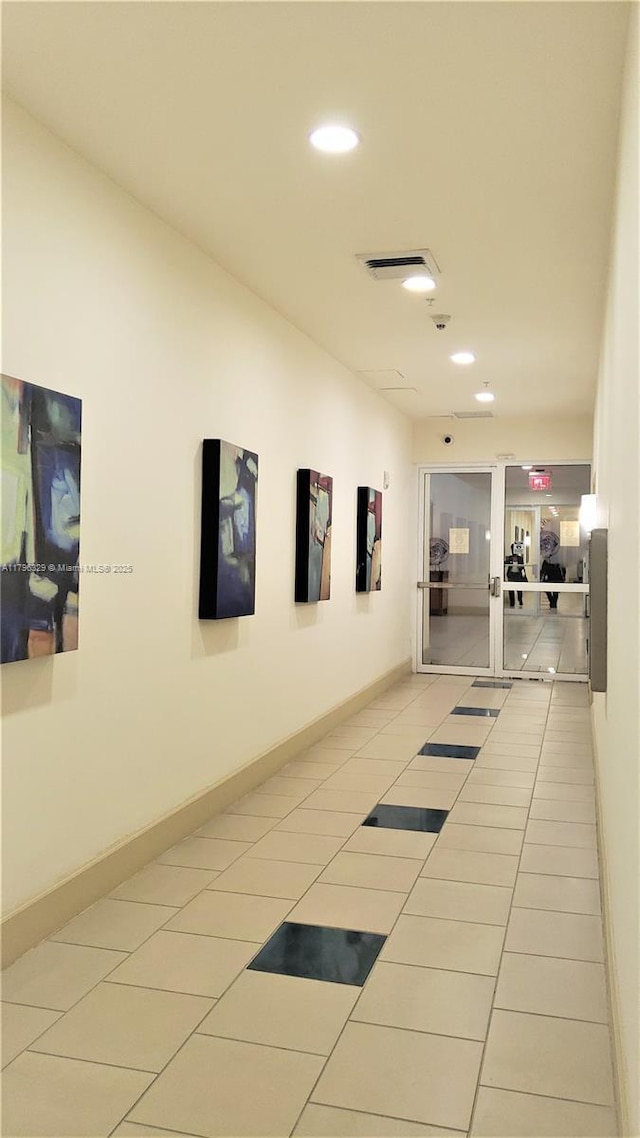 hallway with baseboards, recessed lighting, visible vents, and light tile patterned flooring
