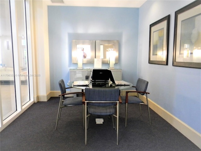 office featuring baseboards and dark carpet