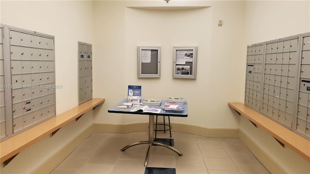 office area featuring tile patterned floors, baseboards, and mail area