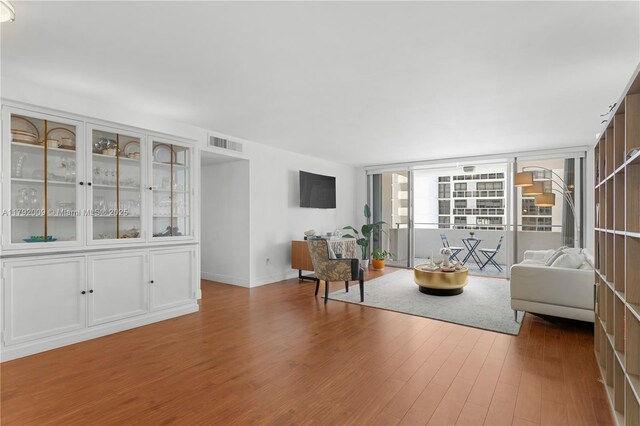 11 Island Ave Unit 407, Miami Beach, FL 33139 - living room featuring wood finished floors and expansive windows