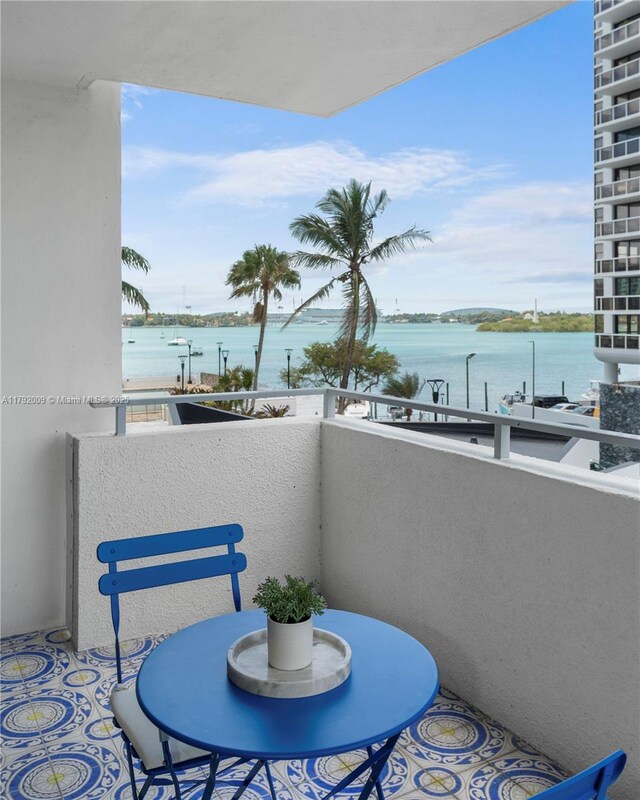 11 Island Ave Unit 407, Miami Beach, FL 33139 - kitchen with stainless steel appliances, a sink, wood finished floors, and brown cabinets