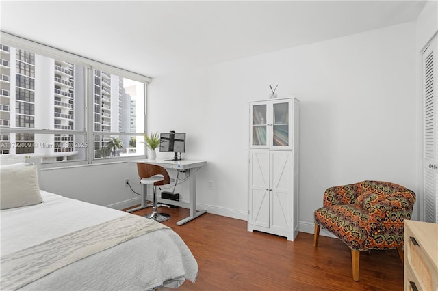 bedroom with wood finished floors and baseboards